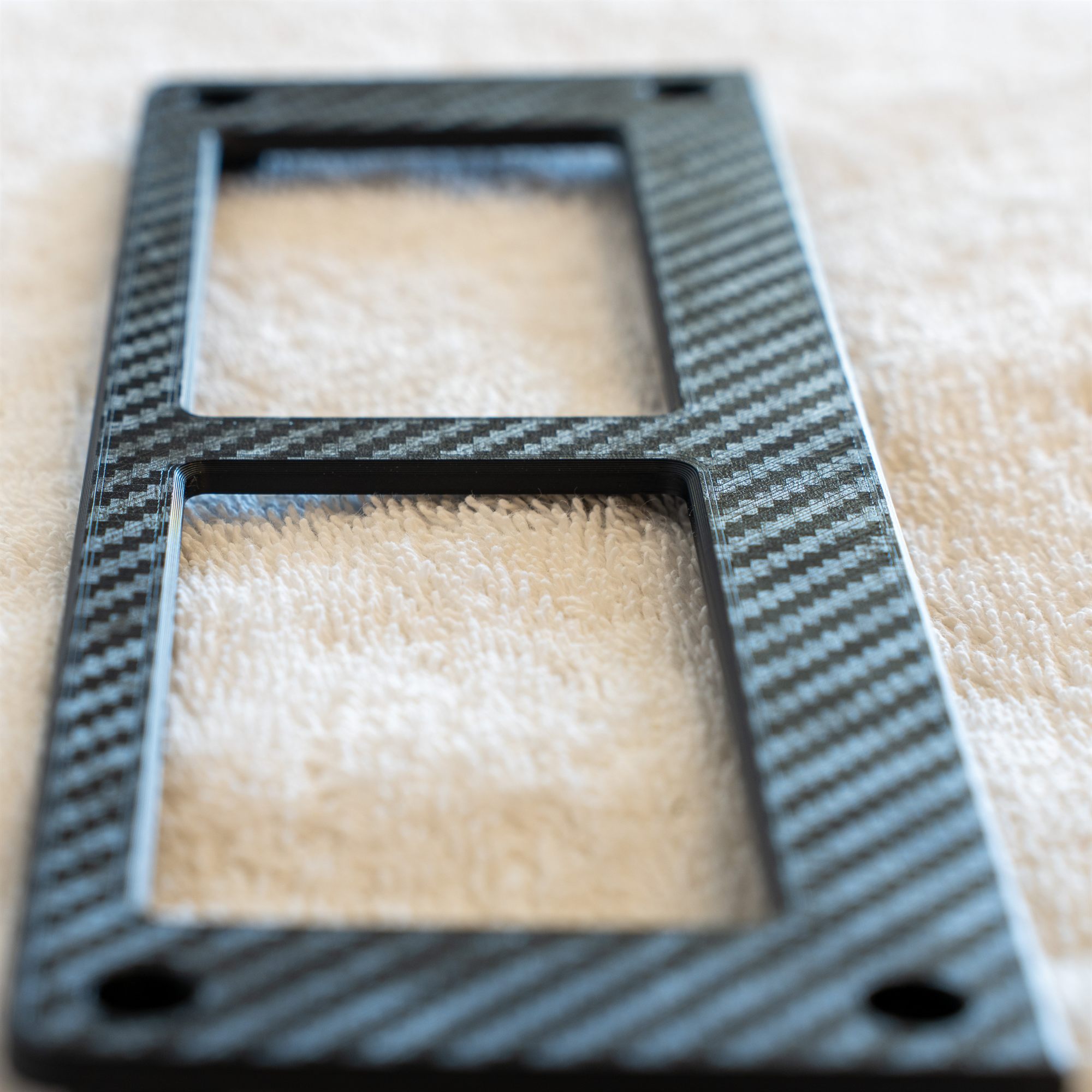 Close-up of the carbon weave texture on a Fiero aux gauge cover