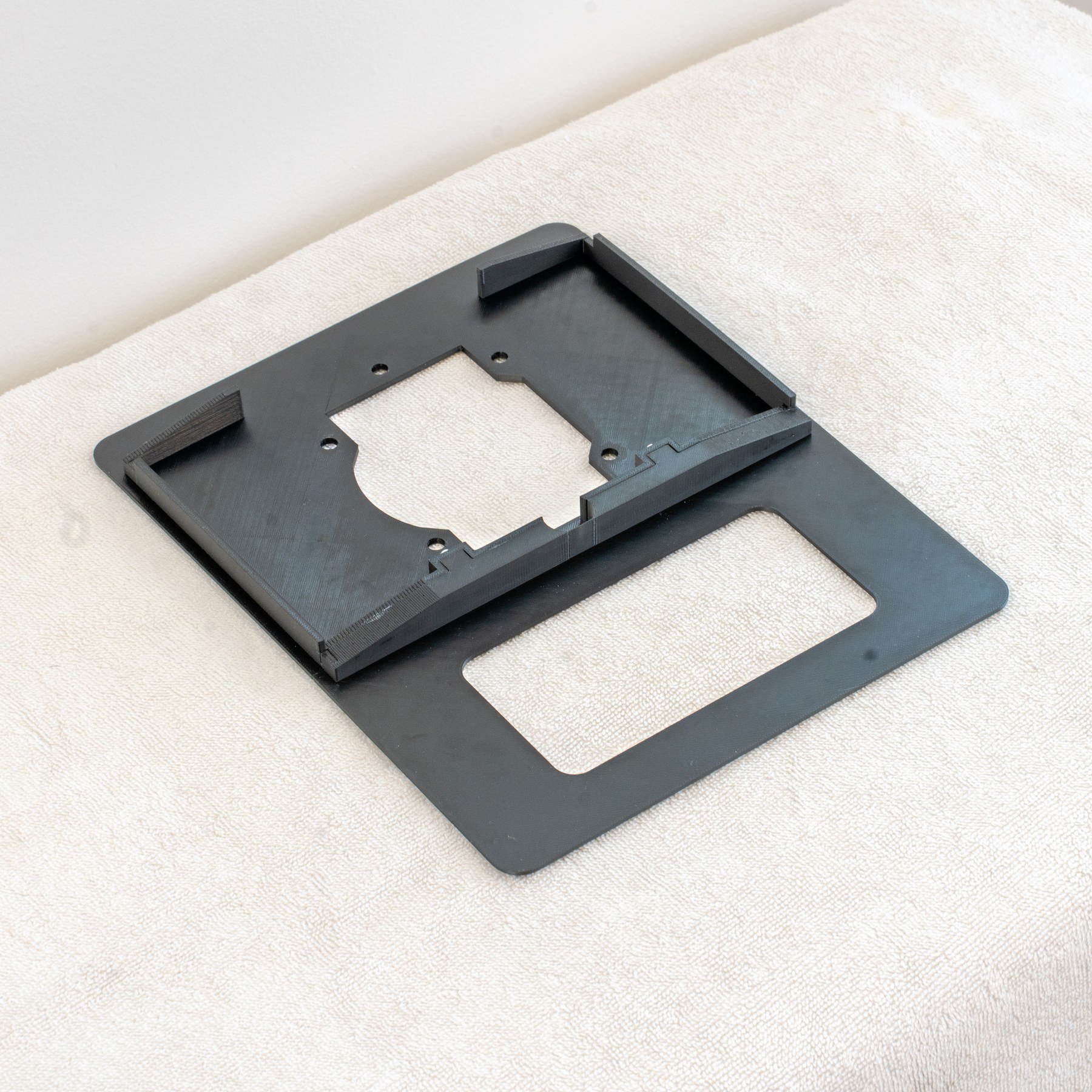 Underside of a reproduction Fiero solid-top shifter bezel at an angle, showing the shifter opening