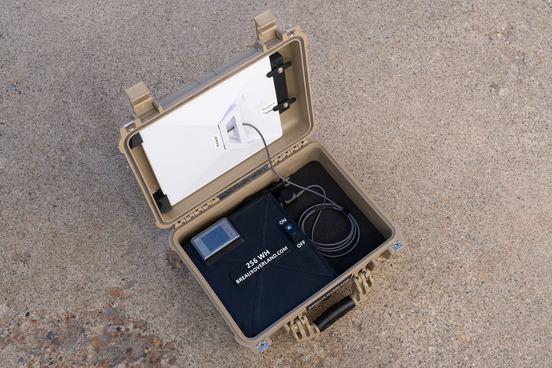 Open Starlink Mini power kit on concrete, seen from the side